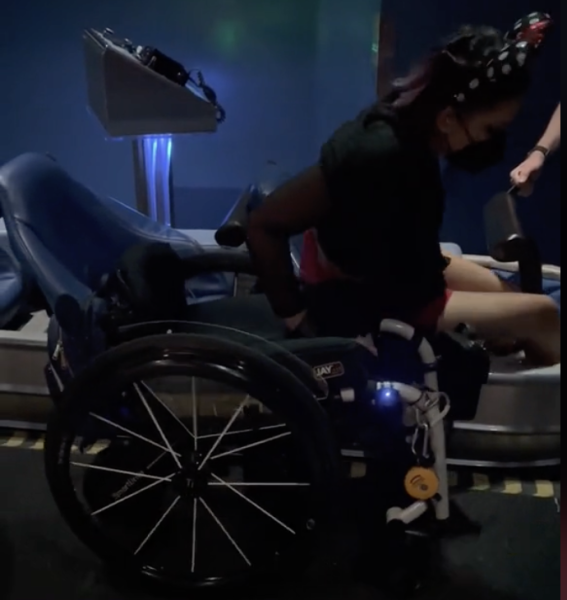 Wheelchair user transferring out of Space Mountain