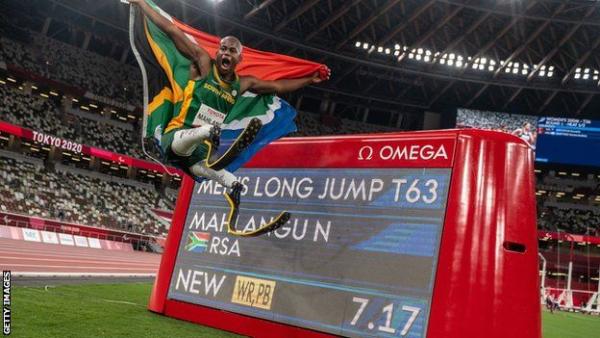 Team South Africa's Ntandu Mahlangu next to his Long Jump World Record Sign